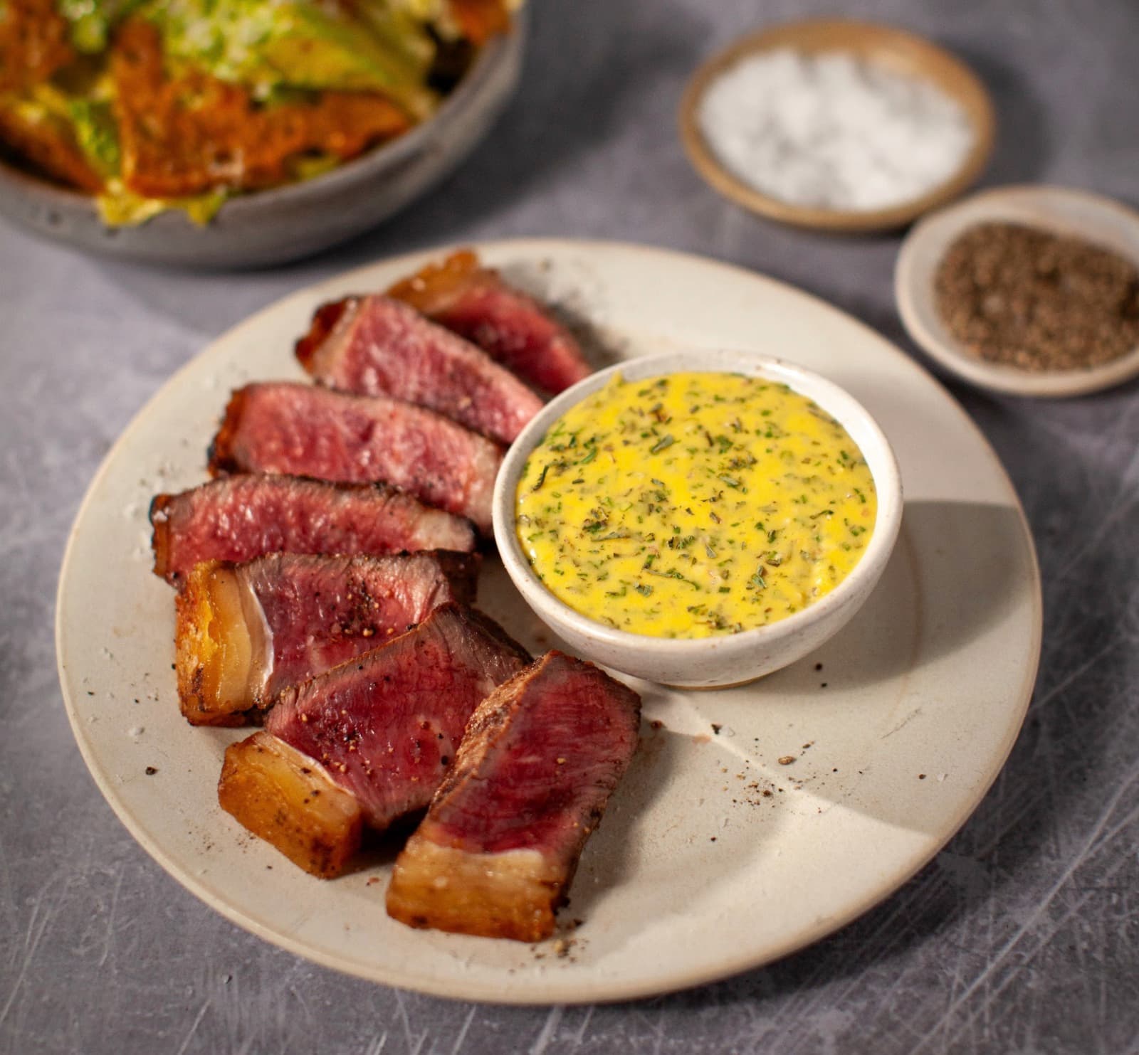 Barbecued striploin steak with a bearnaise sauce and the classic Caesar salad