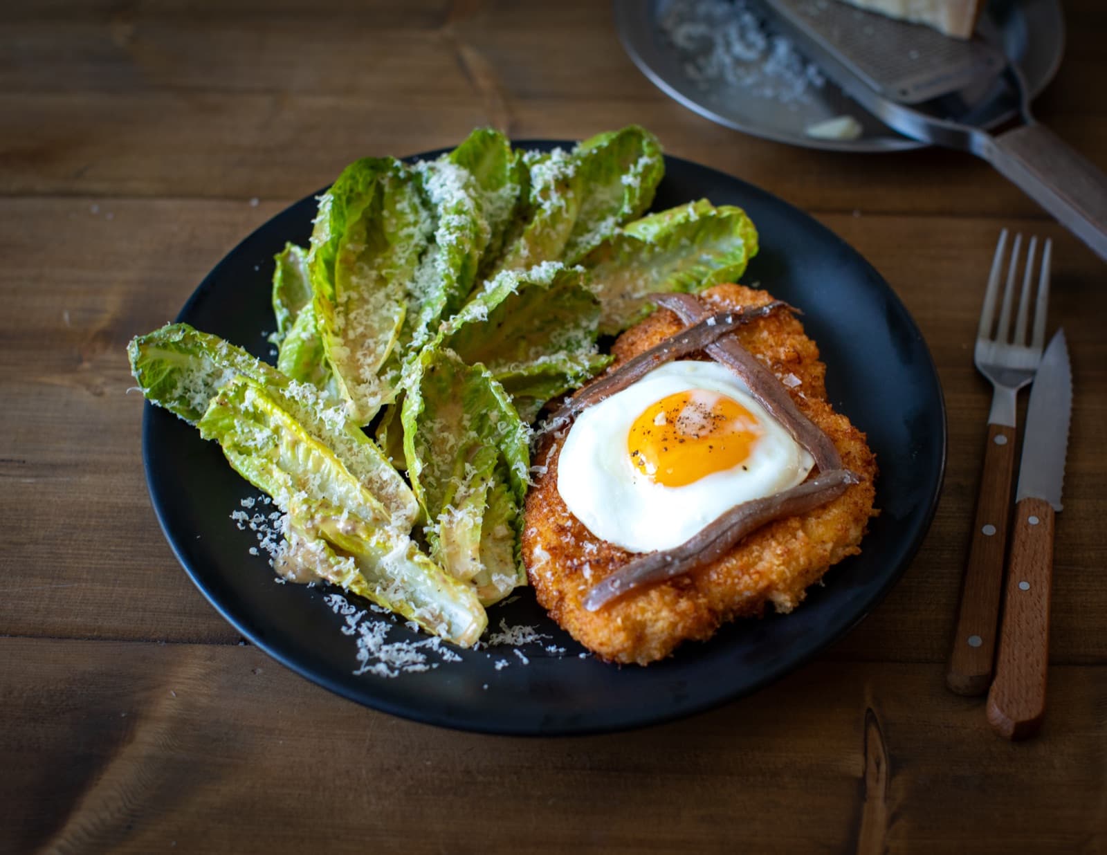 Chicken Schnitzel with fried egg and Caesar salad